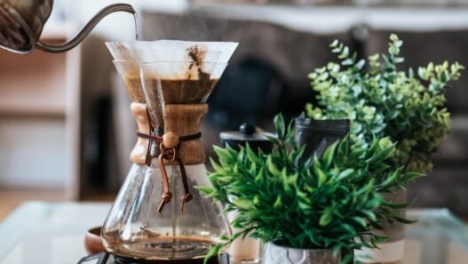 person pouring coffee ion jar