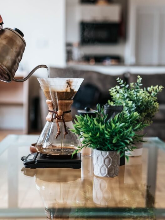 person pouring coffee ion jar